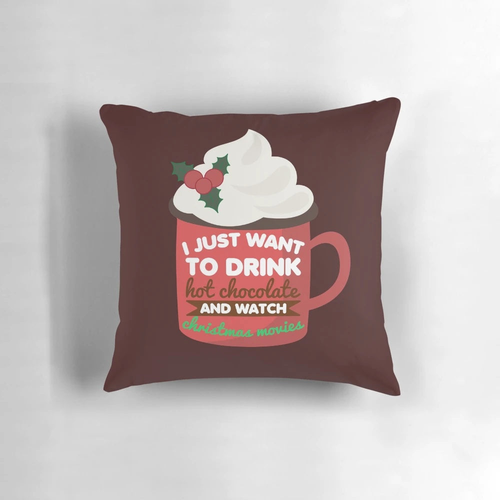 Funny Christmas pillow with a hand-drawn design of a person drinking hot chocolate while watching holiday movies.
