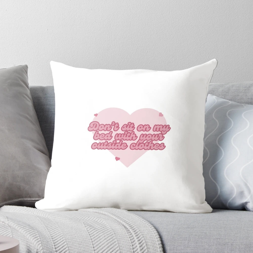 A plush, customizable pillow that reads "Don't sit on my bed with your outside clothes" in a playful, relatable design.