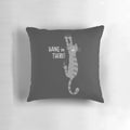 Gray striped tabby cat hanging on a pillow with the text "Hang in There!