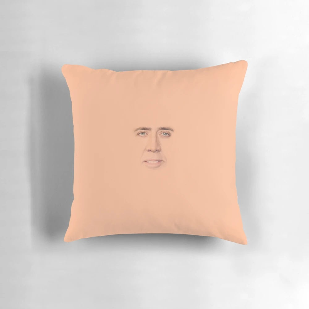 Funny and quirky Nicolas Cage face printed on a small, decorative throw pillow