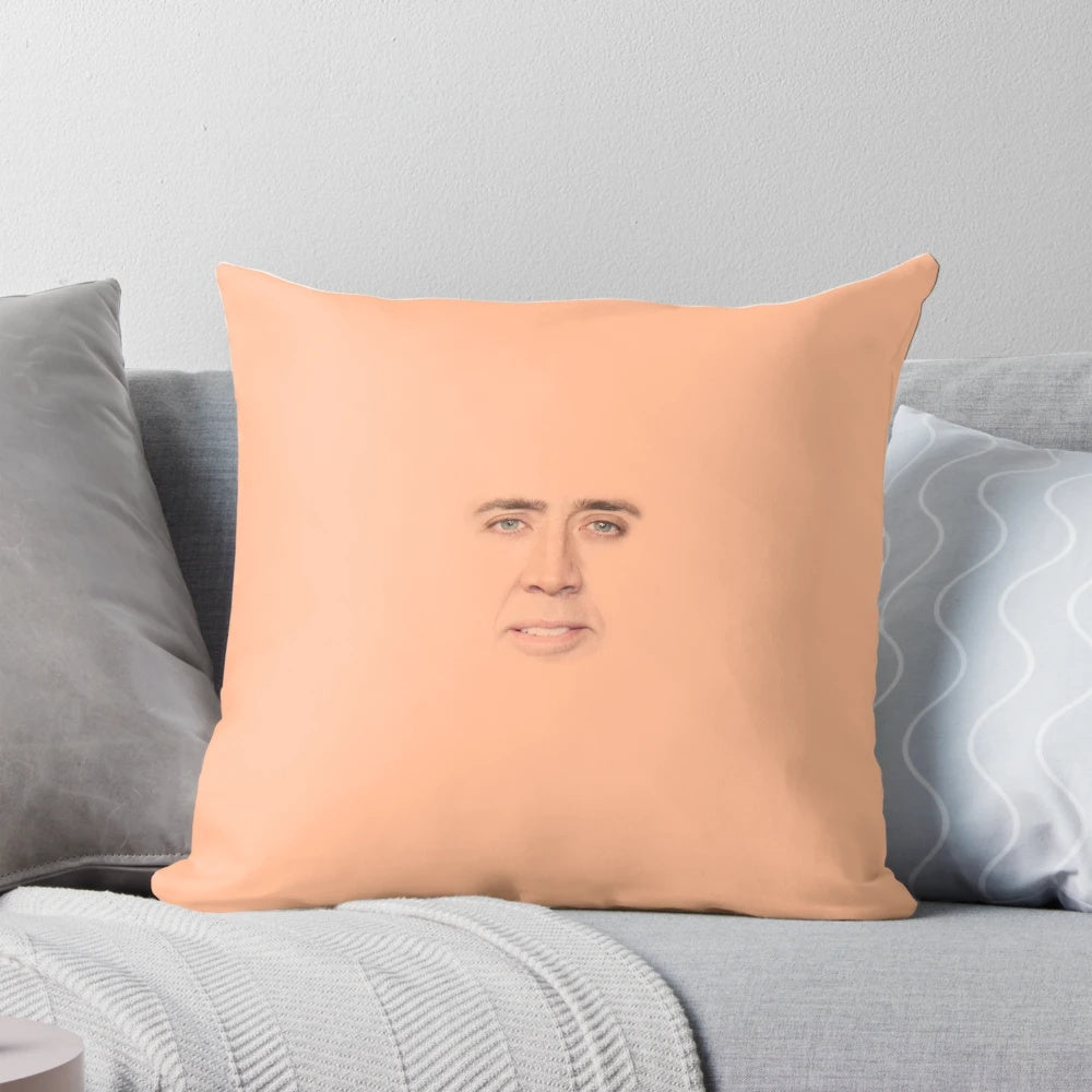 Funny and quirky Nicolas Cage face printed on a small, decorative throw pillow
