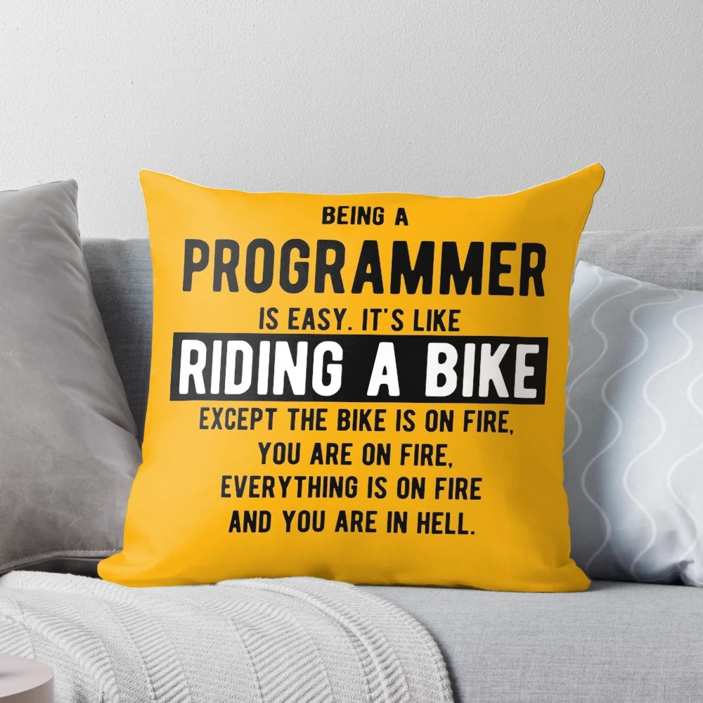 Light color pillow with a funny programming joke - "Being a programmer is easy. It's like riding a bike.