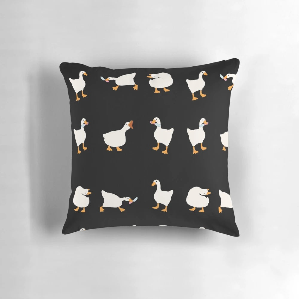 A soft, plush pillow featuring a cute and funny illustration of a duck and goose with knives, inspired by the popular video game Untitled Goose Game.