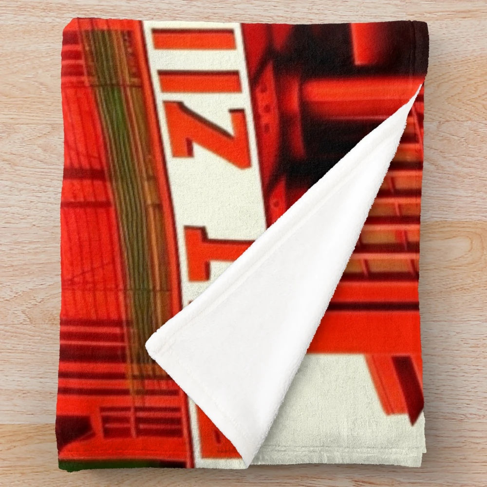 Futuristic city-inspired plush blanket with red, green, black, and white colors
