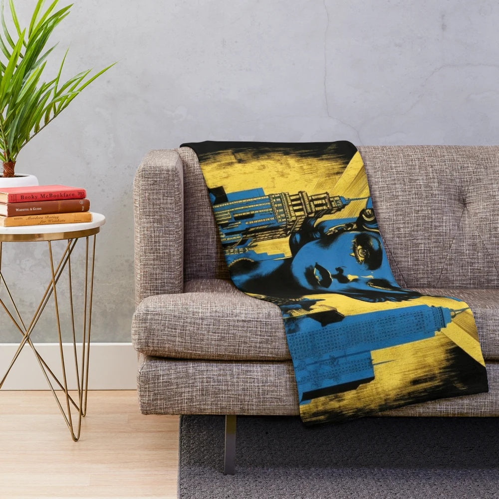 Plush blanket featuring a futuristic Metropolis city movie theater design