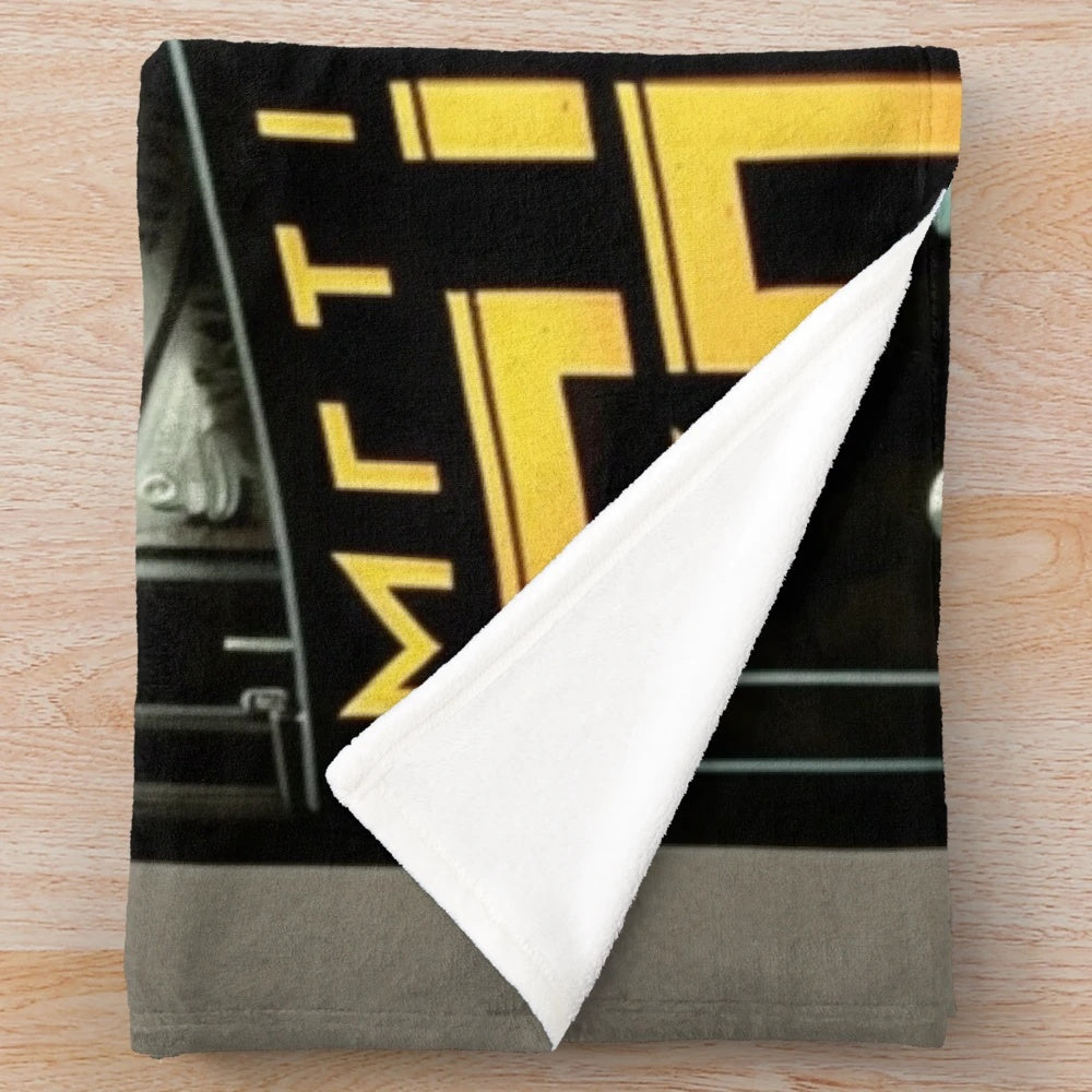Futuristic plush blanket with abstract gray, black, and yellow cinema-inspired design