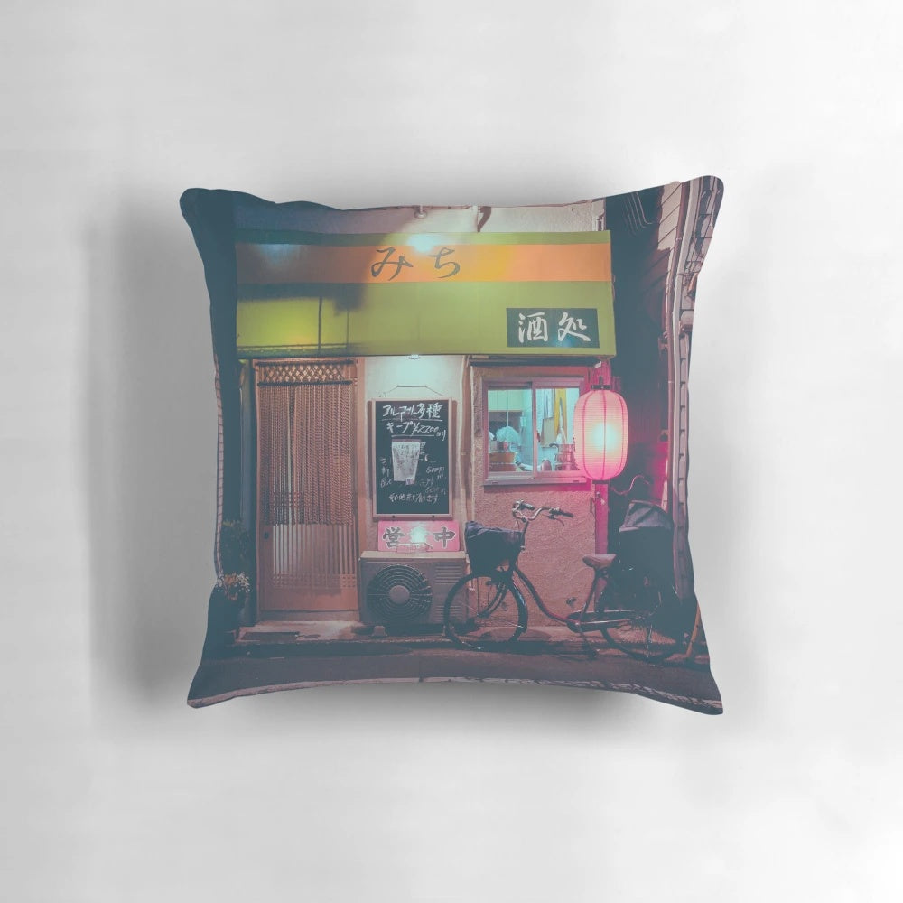 A futuristic pillow with a vibrant street scene of a Tokyo ramen alley, featuring neon lights, lanterns, and a bicycle