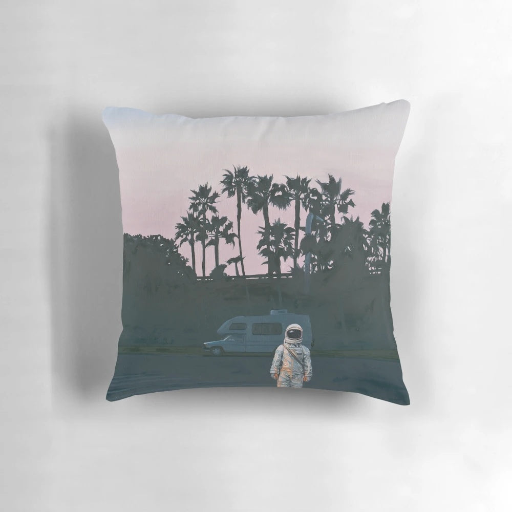 A vibrant, space-themed pillow featuring an artistic sunset landscape with palm trees and an astronaut, perfect for RV decor.