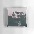 A vibrant, space-themed pillow featuring an artistic sunset landscape with palm trees and an astronaut, perfect for RV decor.