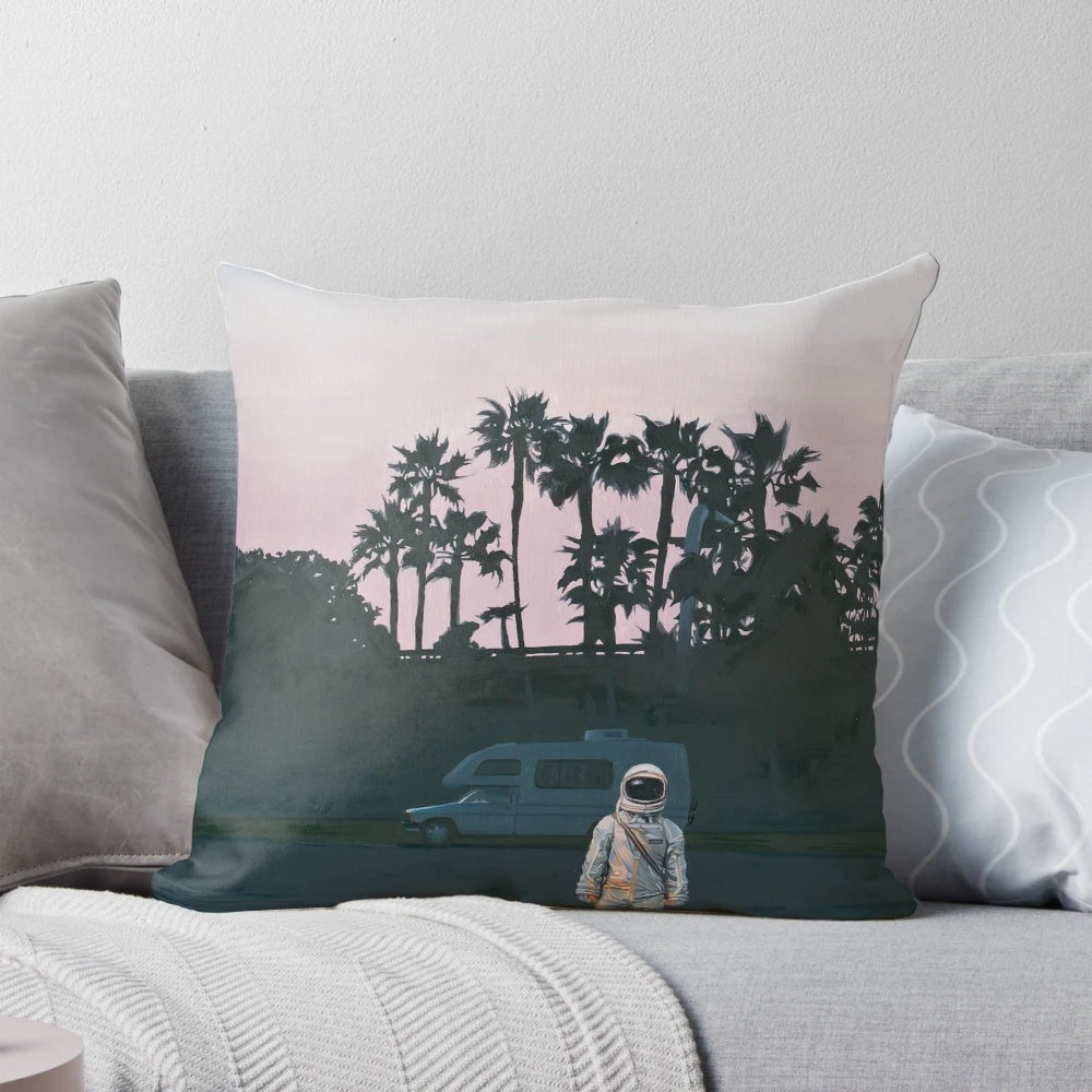 A vibrant, space-themed pillow featuring an artistic sunset landscape with palm trees and an astronaut, perfect for RV decor.