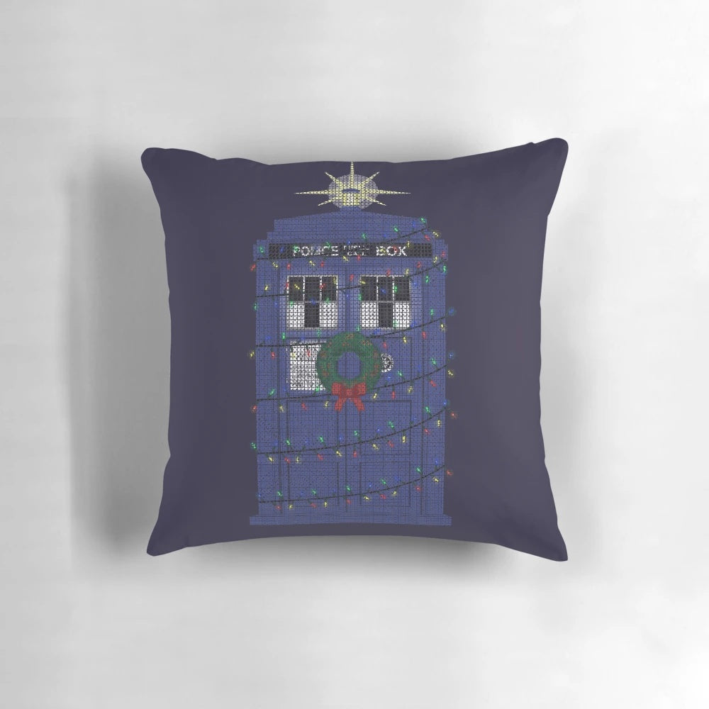 A cozy knitted pillow featuring the iconic Doctor Who police box design, perfect for festive sci-fi fans.