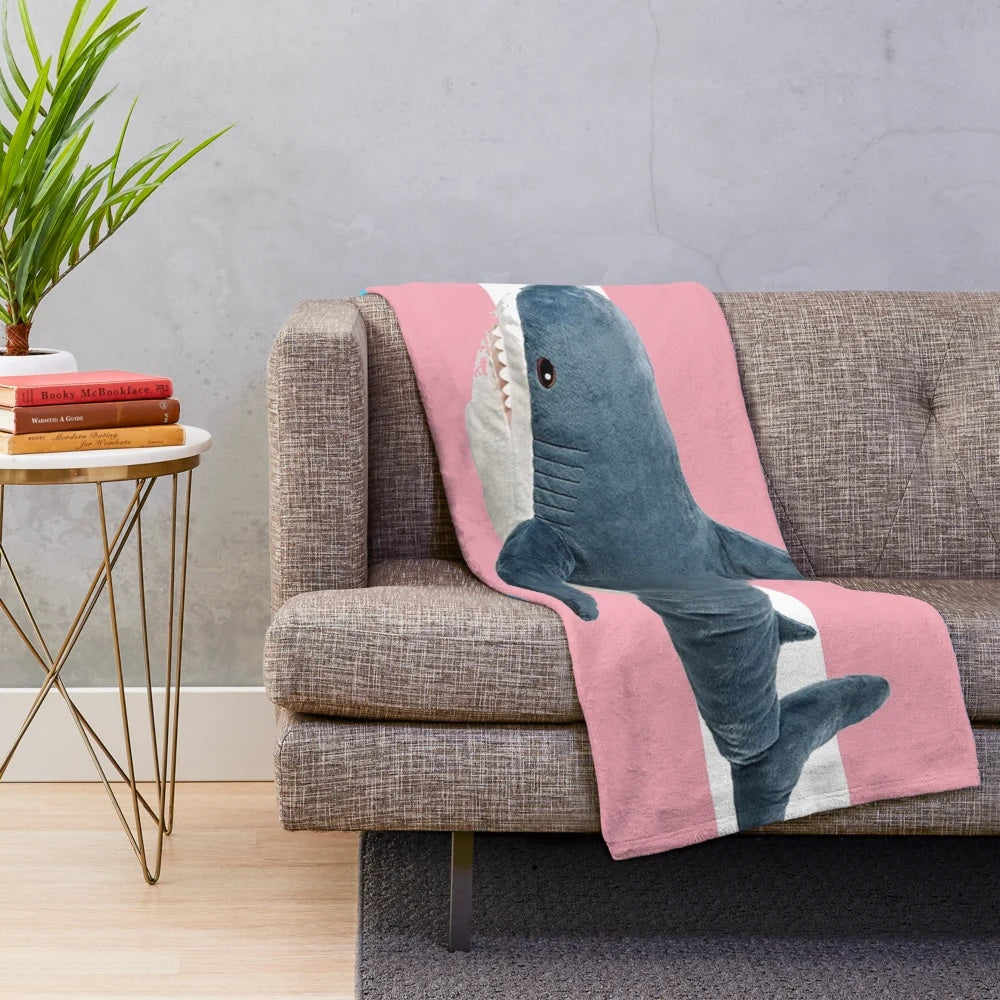 Cozy plush blanket featuring a trans pride design on a shark character