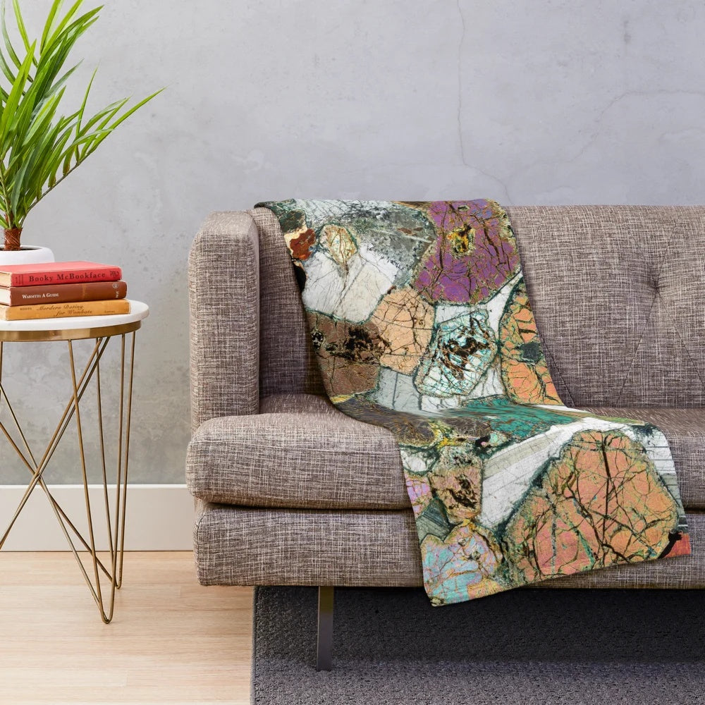 Plush blanket featuring a microscope photo of peridotite rock from Scotland
