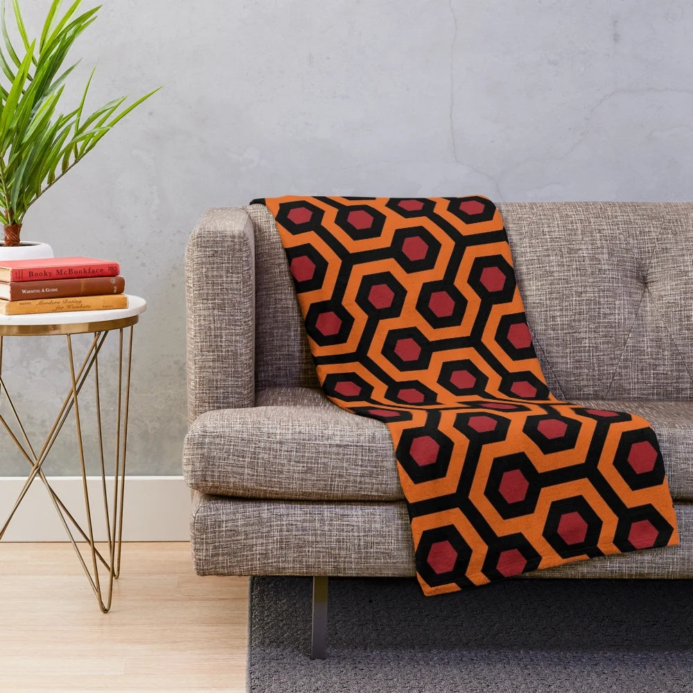 Geometric and abstract plush blanket featuring the iconic Overlook Hotel carpet pattern