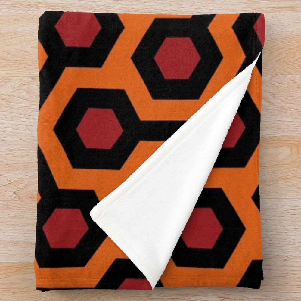 Geometric and abstract plush blanket featuring the iconic Overlook Hotel carpet pattern