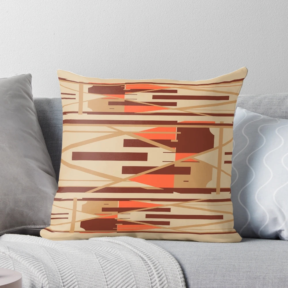 Geometric abstract design pillow in shades of tan, orange, and brown.