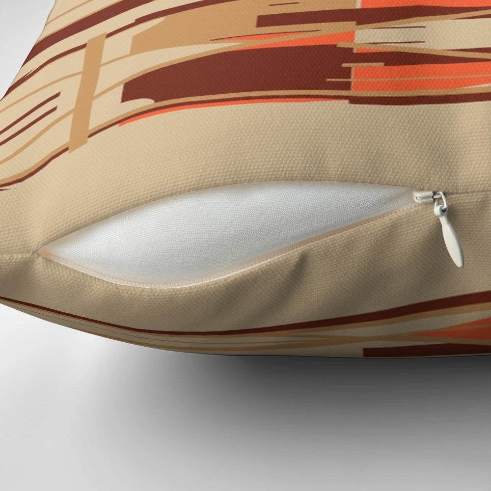 Geometric abstract design pillow in shades of tan, orange, and brown.