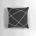 Geometric abstract throw pillow in black and white design, modern minimalist home accent.