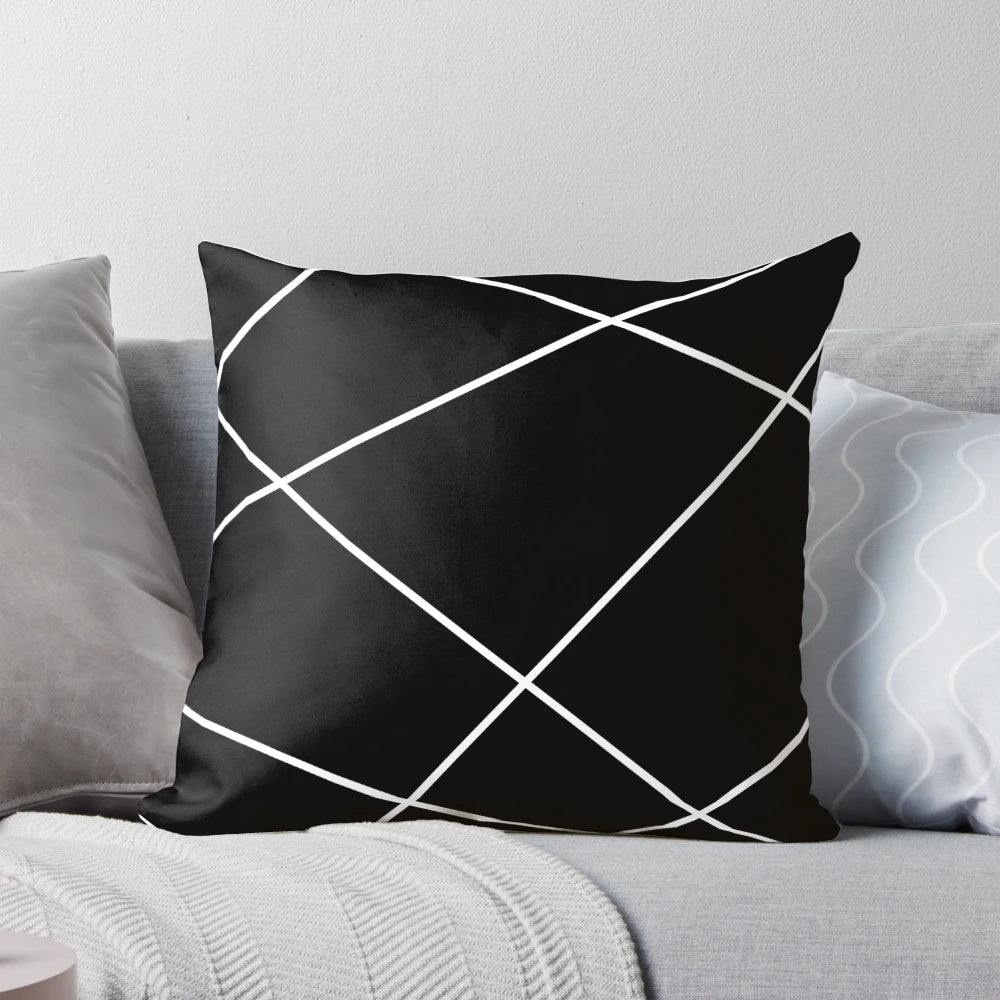 Geometric abstract throw pillow in black and white design, modern minimalist home accent.