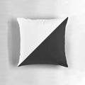 A modern, abstract black and white diagonal pillow with a geometric polygon pattern.