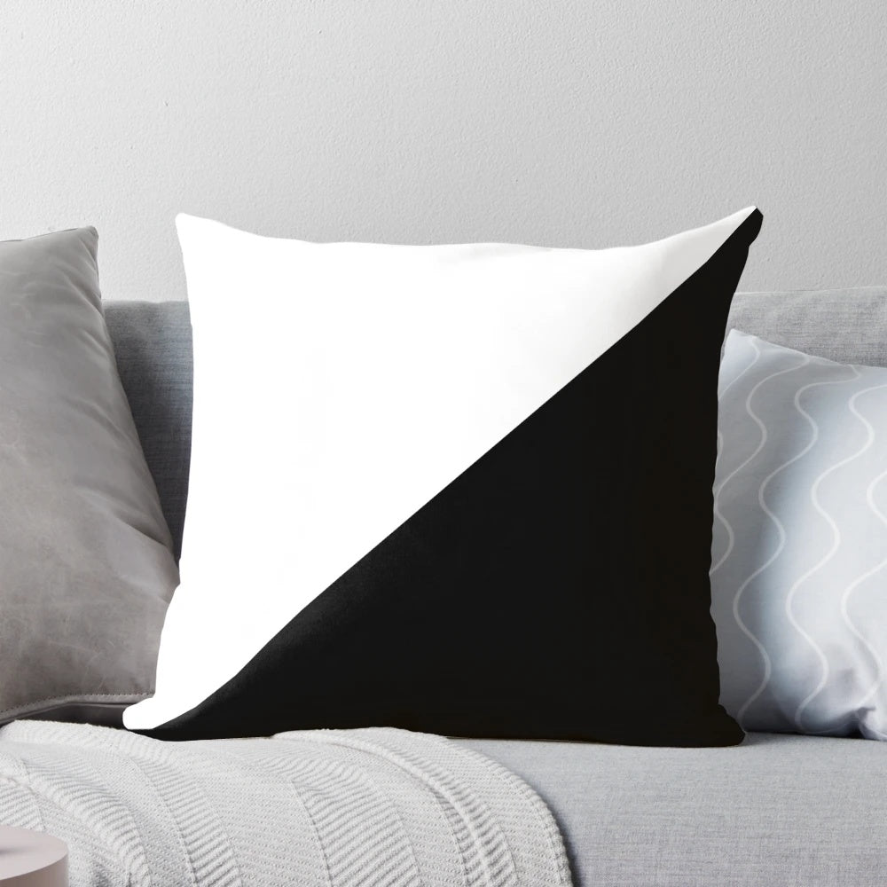 A modern, abstract black and white diagonal pillow with a geometric polygon pattern.