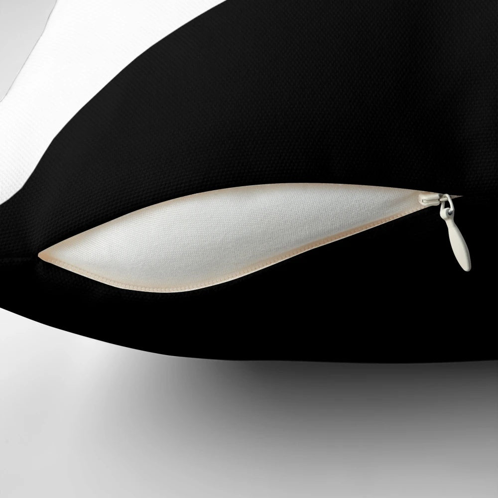 A modern, abstract black and white diagonal pillow with a geometric polygon pattern.