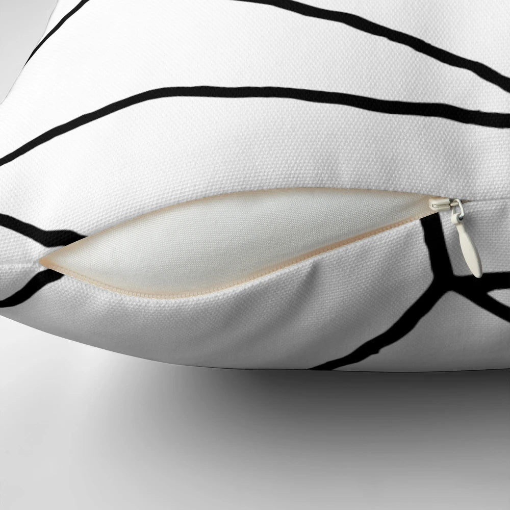 Geometric black and white throw pillow with a modern, minimalist design featuring mosaic lines and a square shape.