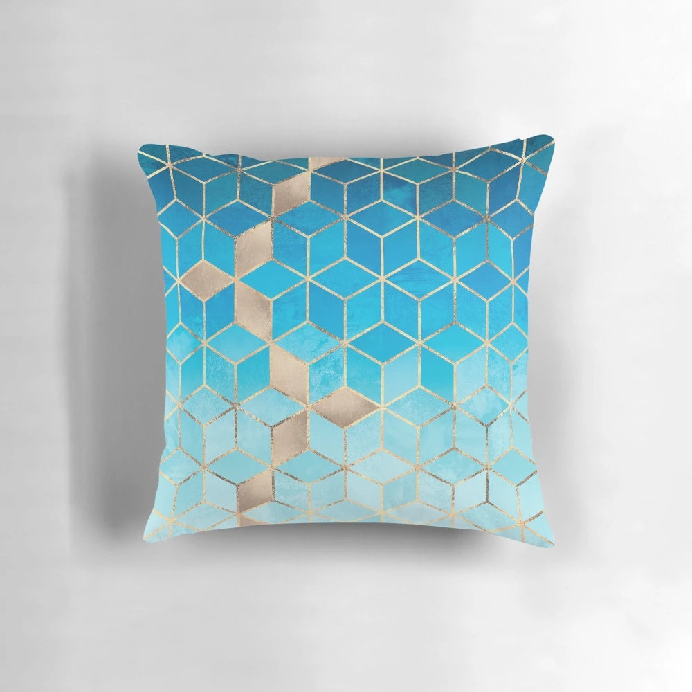 Decorative pillow featuring a modern geometric cubist design in shades of blue and gold