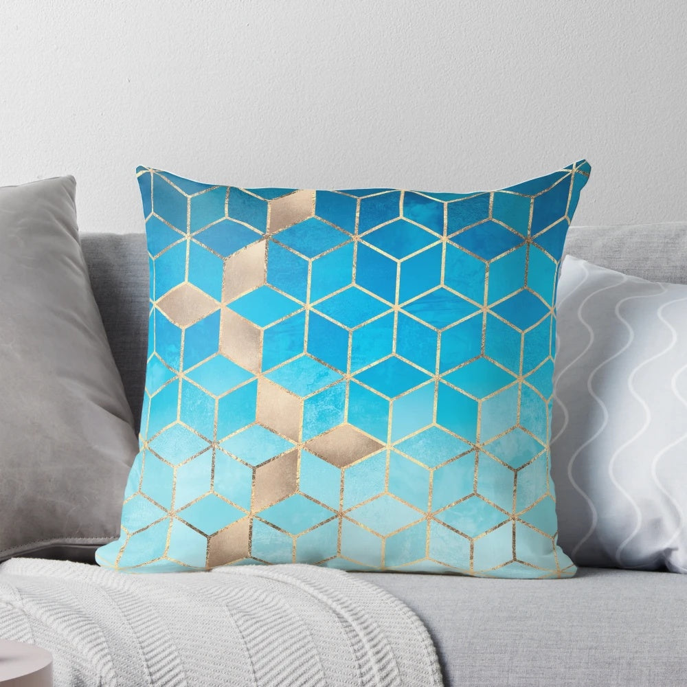 Decorative pillow featuring a modern geometric cubist design in shades of blue and gold