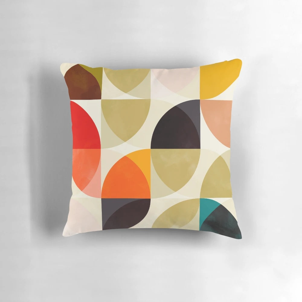 Set of four mid-century inspired throw pillows featuring geometric patterns in autumn colors.