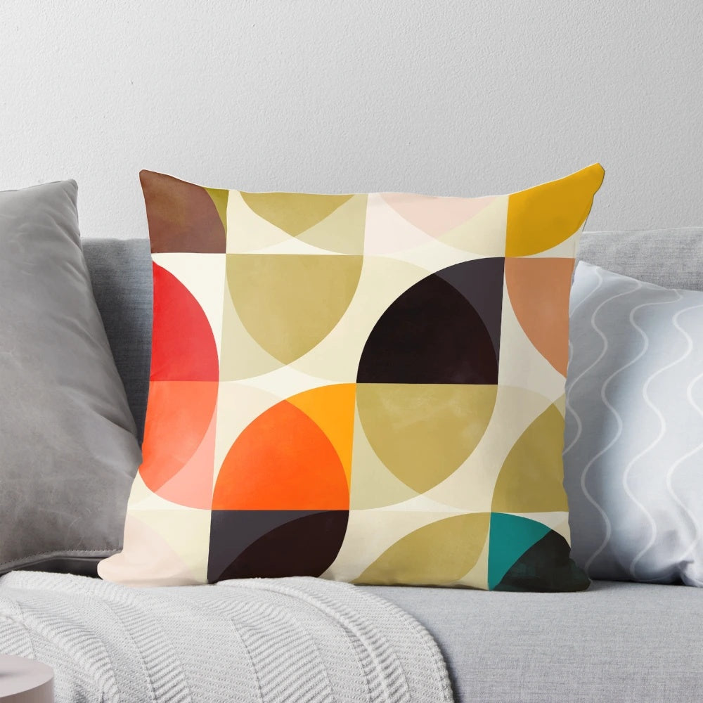 Set of four mid-century inspired throw pillows featuring geometric patterns in autumn colors.