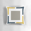 A square pillow with a geometric pattern in light mustard yellow, navy blue, white, and grey colors.