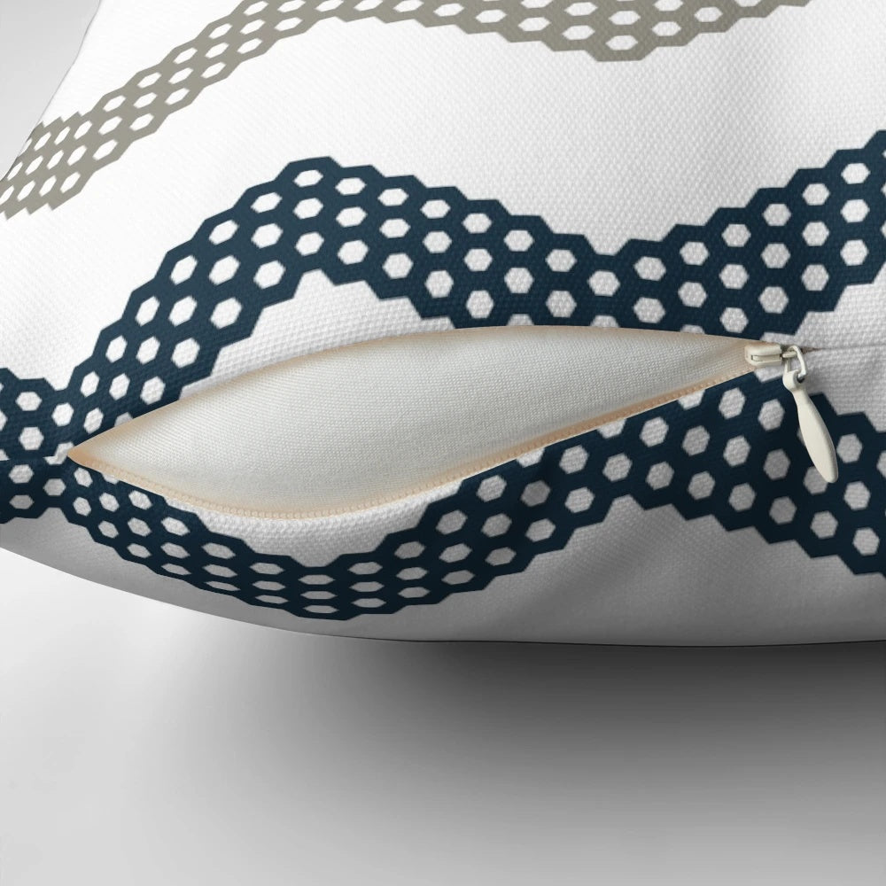 A decorative throw pillow featuring a minimalist honeycomb chevron pattern in shades of mustard yellow, dark blue, grey, and white.
