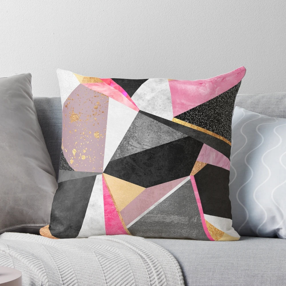 A soft, square pillow with a vibrant, geometric pink and white abstract pattern design.