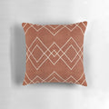 Nudo in Rust Pillow - a geometric, boho-inspired accent pillow with a rust, red, and white color scheme