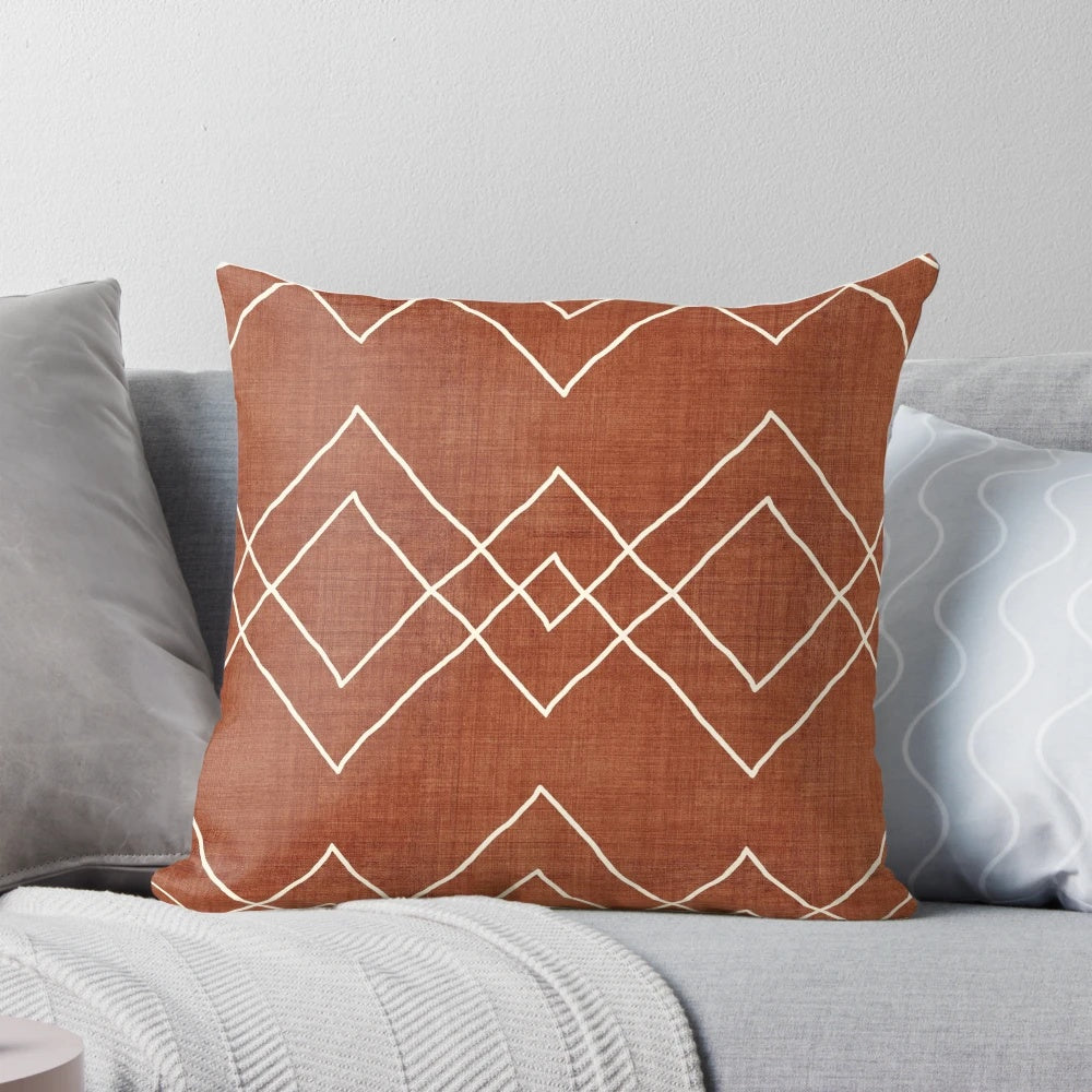 Nudo in Rust Pillow - a geometric, boho-inspired accent pillow with a rust, red, and white color scheme