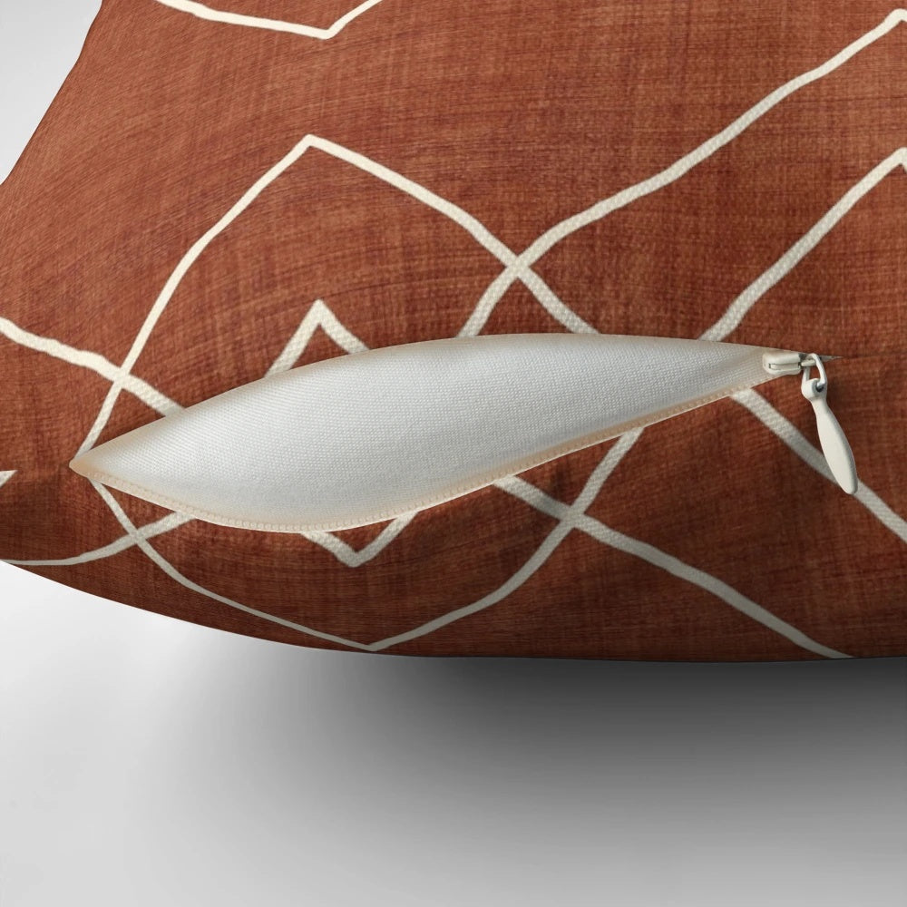 Nudo in Rust Pillow - a geometric, boho-inspired accent pillow with a rust, red, and white color scheme