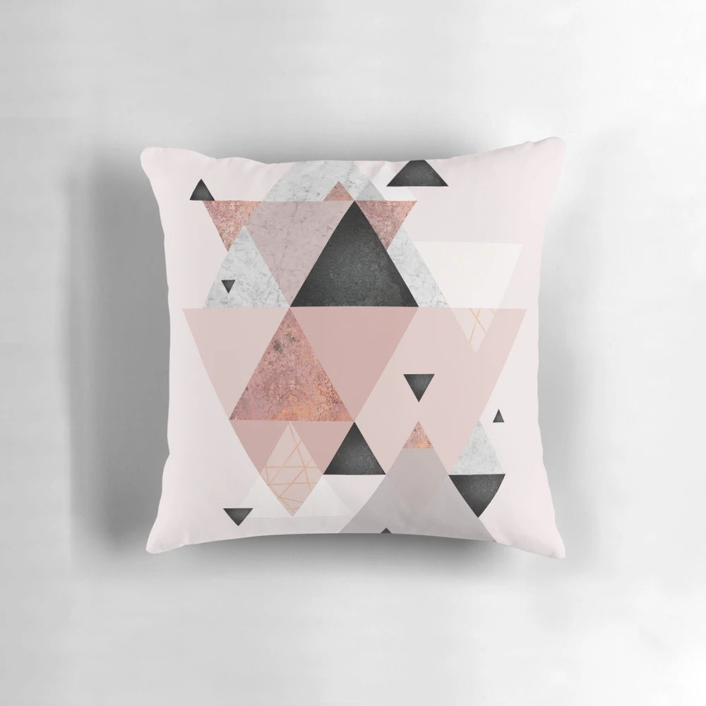 Stylish geometric throw pillow in blush pink and rose gold tones, perfect for modern Scandinavian-inspired home decor.