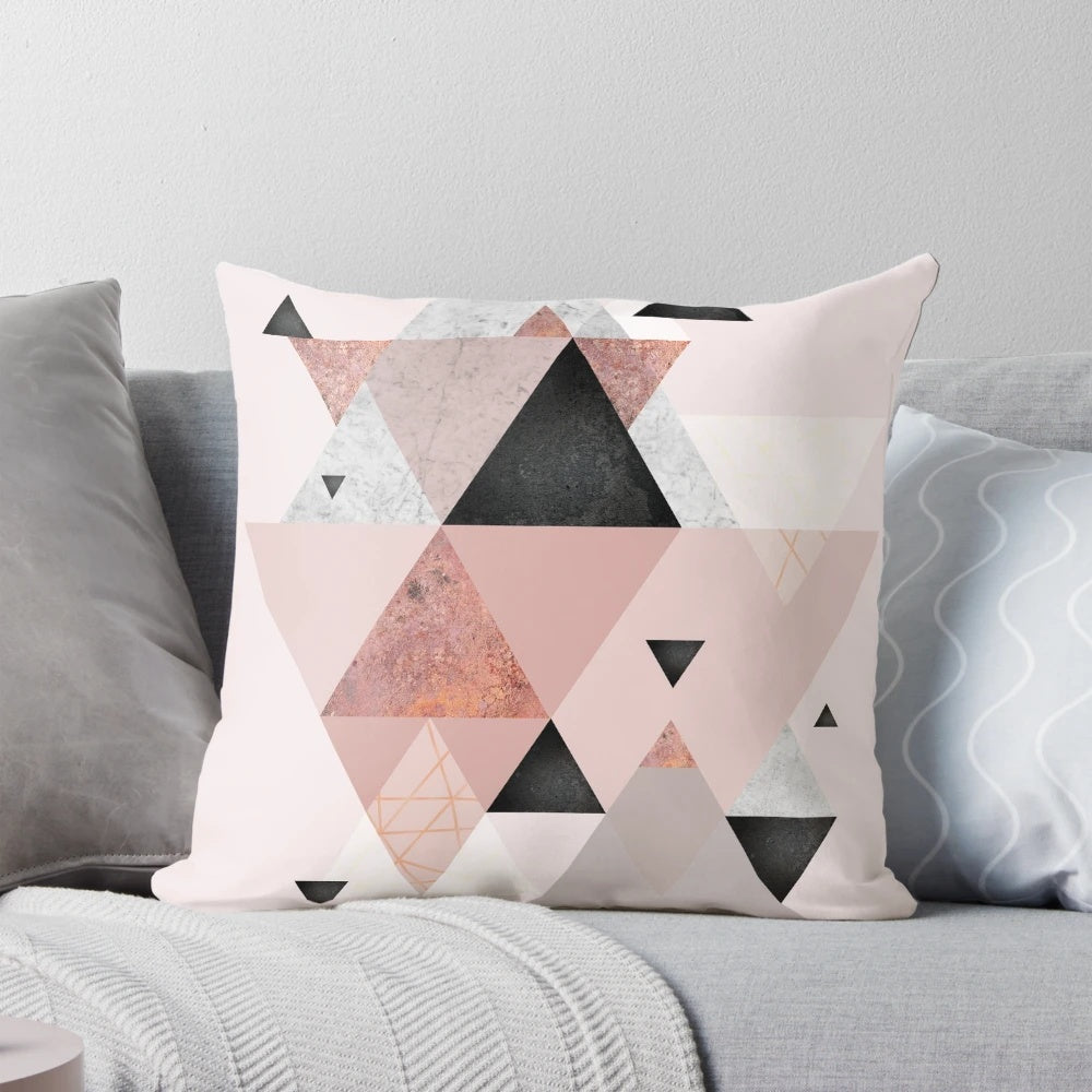 Stylish geometric throw pillow in blush pink and rose gold tones, perfect for modern Scandinavian-inspired home decor.