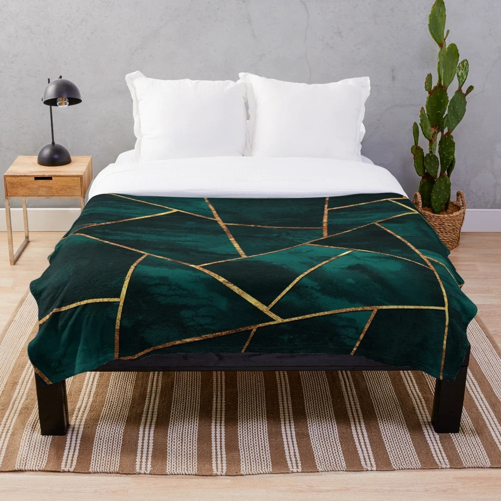 Geometric teal plush blanket with copper and gold accents