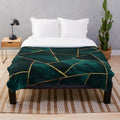 Geometric teal plush blanket with copper and gold accents