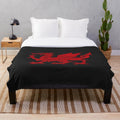 Soft, plush geometric blanket featuring the iconic Welsh dragon design in red and white.