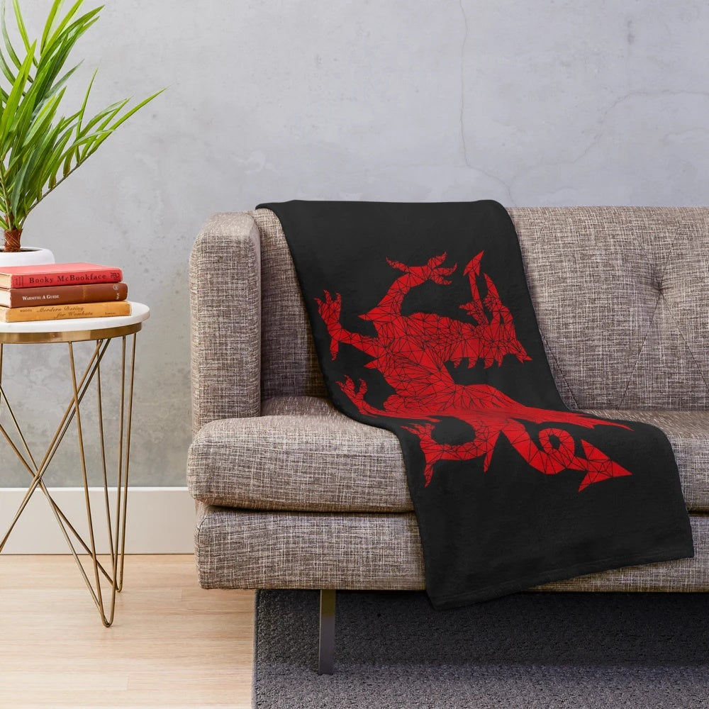 Soft, plush geometric blanket featuring the iconic Welsh dragon design in red and white.