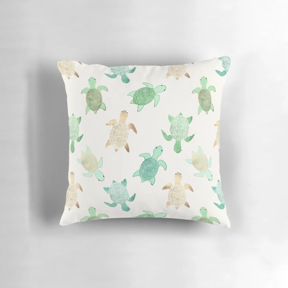 Decorative throw pillow featuring gilded jade and mint turtles, perfect for coastal home decor