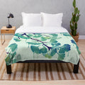 Ginkgo-inspired plush blanket with surreal, drippy green design