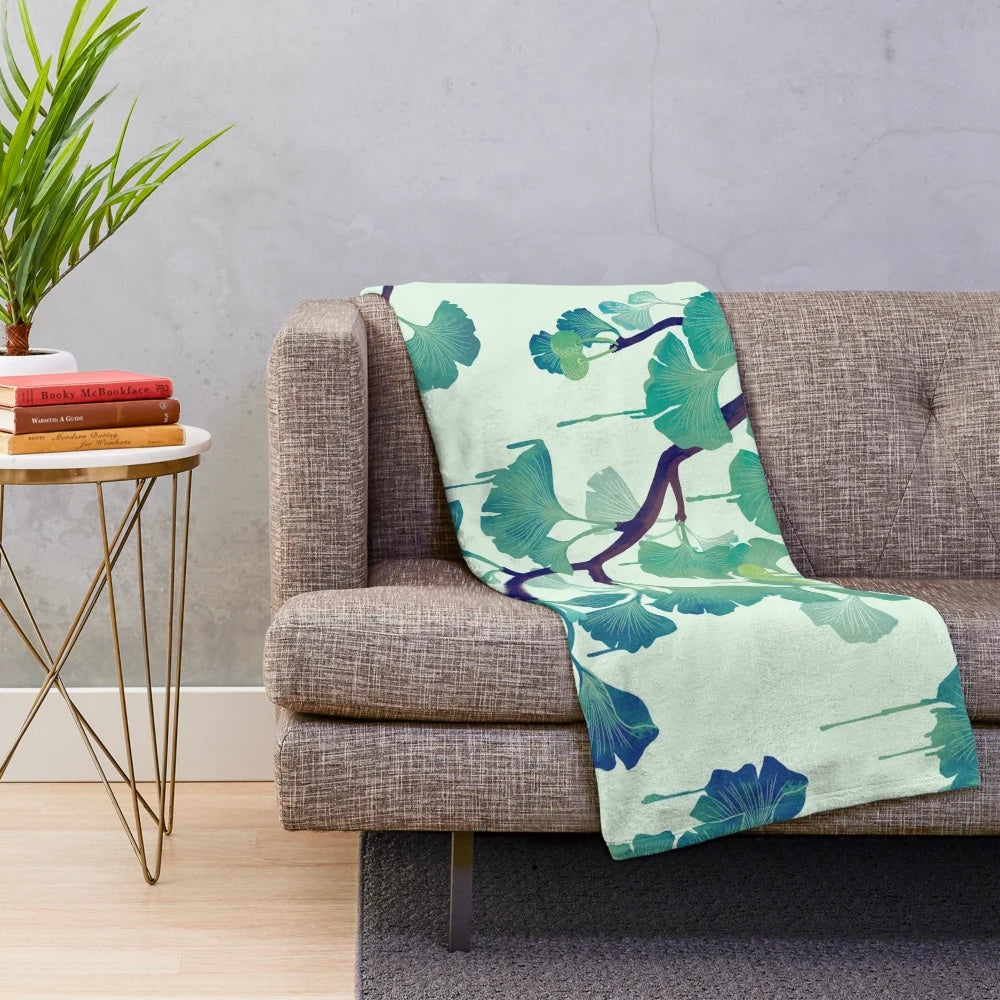 Ginkgo-inspired plush blanket with surreal, drippy green design