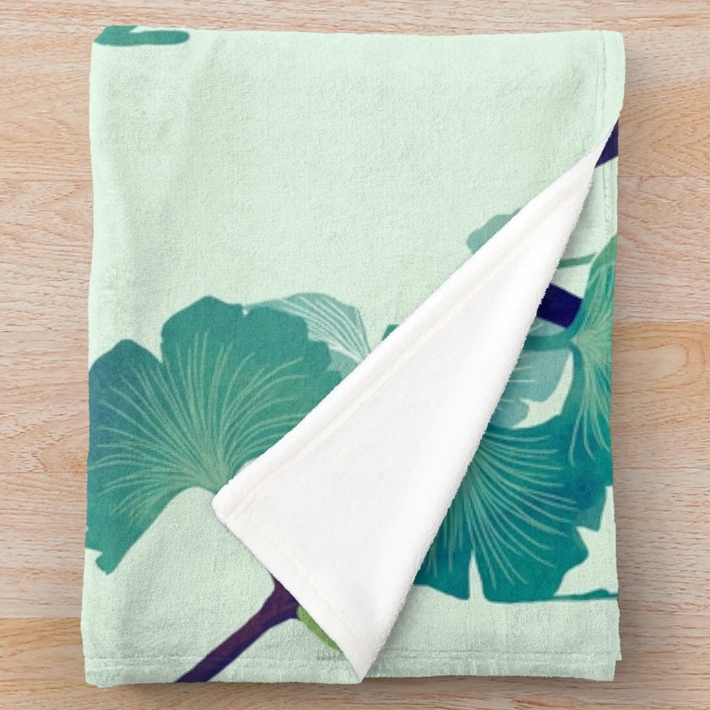Ginkgo-inspired plush blanket with surreal, drippy green design