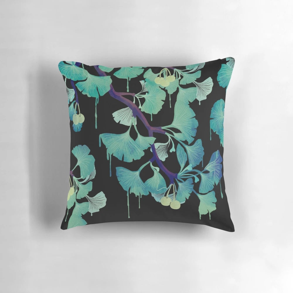 Artistic watercolor painting of ginkgo leaves on a black background, printed on a decorative throw pillow.
