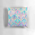 Decorative pillow with an art deco-inspired pastel pattern featuring mermaid scales and fish.