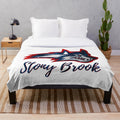 Glittering plush blanket with Stony Brook University design and Wolfie the Seawolf mascot